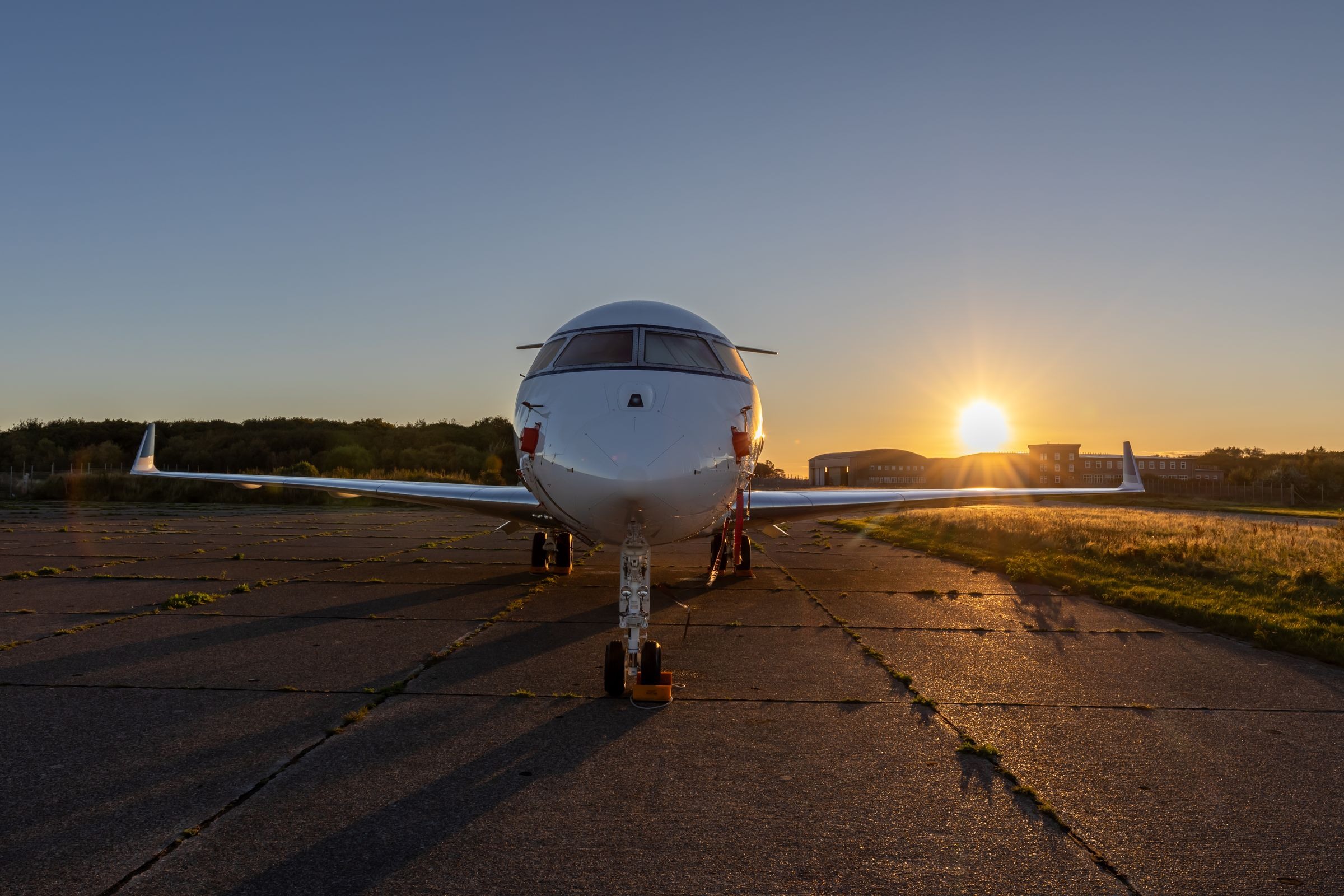 Aircraft parked on an airfield at sunset