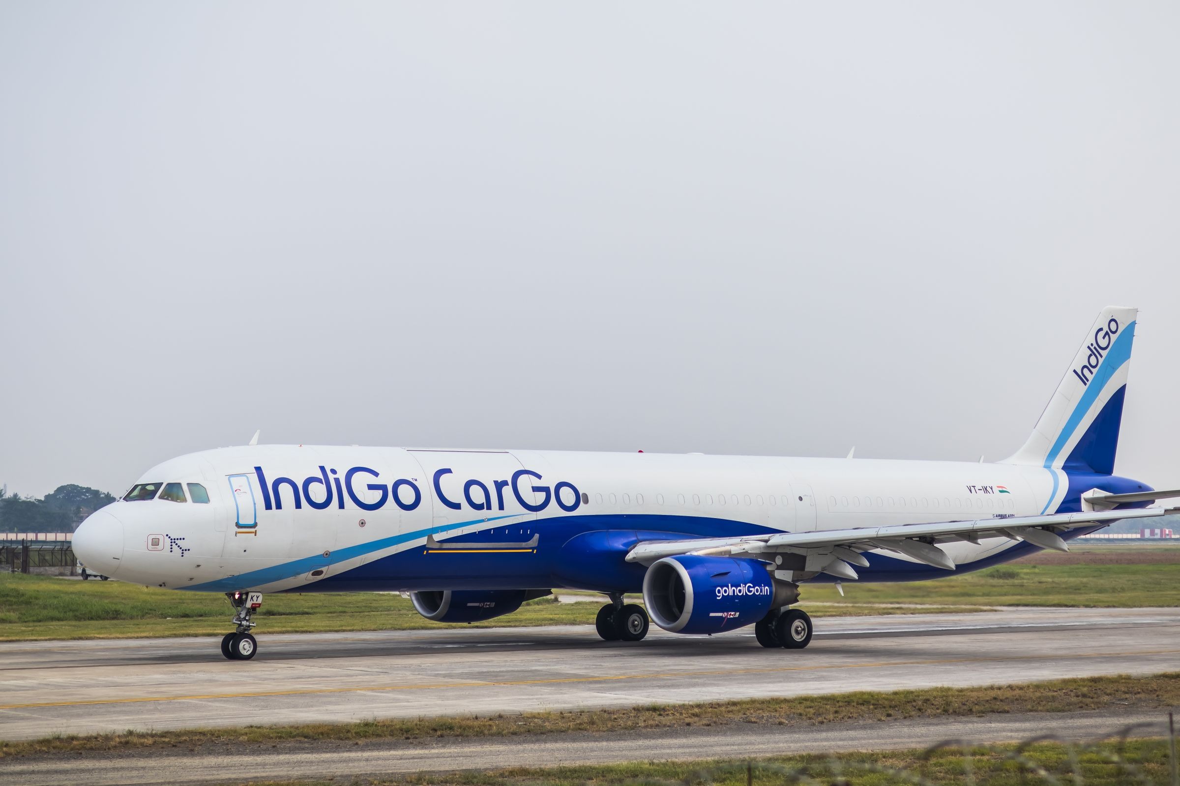 Cargo aircraft and ground handling equipment on a bright airport apron