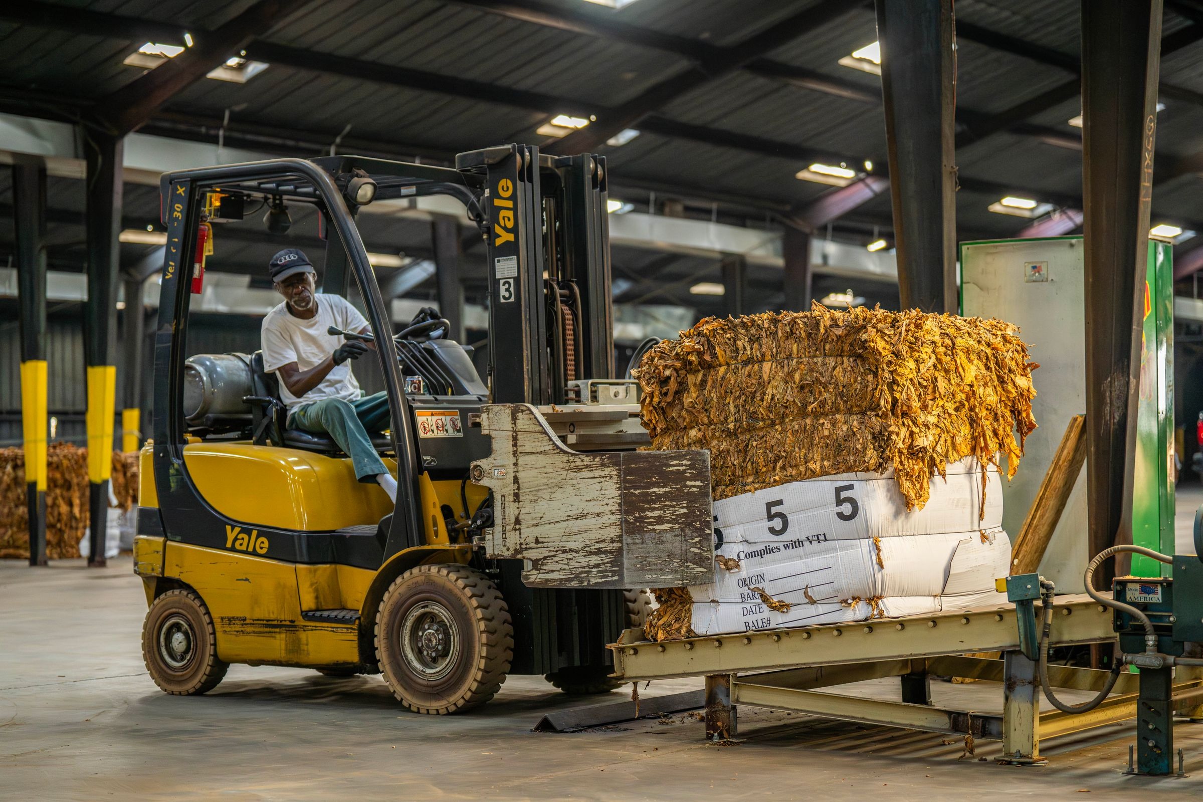 Forklift loading pallet cargo in supplier warehouse