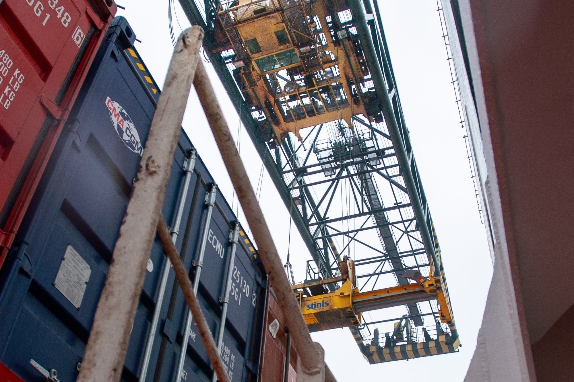 Export shipping container being loaded with crane