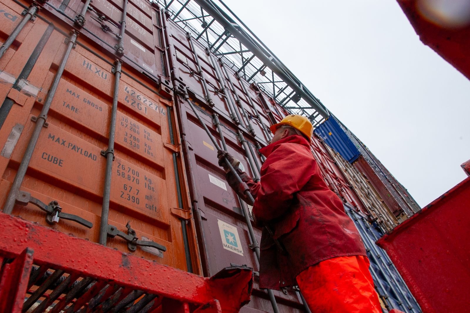 Port worker checking a shipping container at a cargo terminal