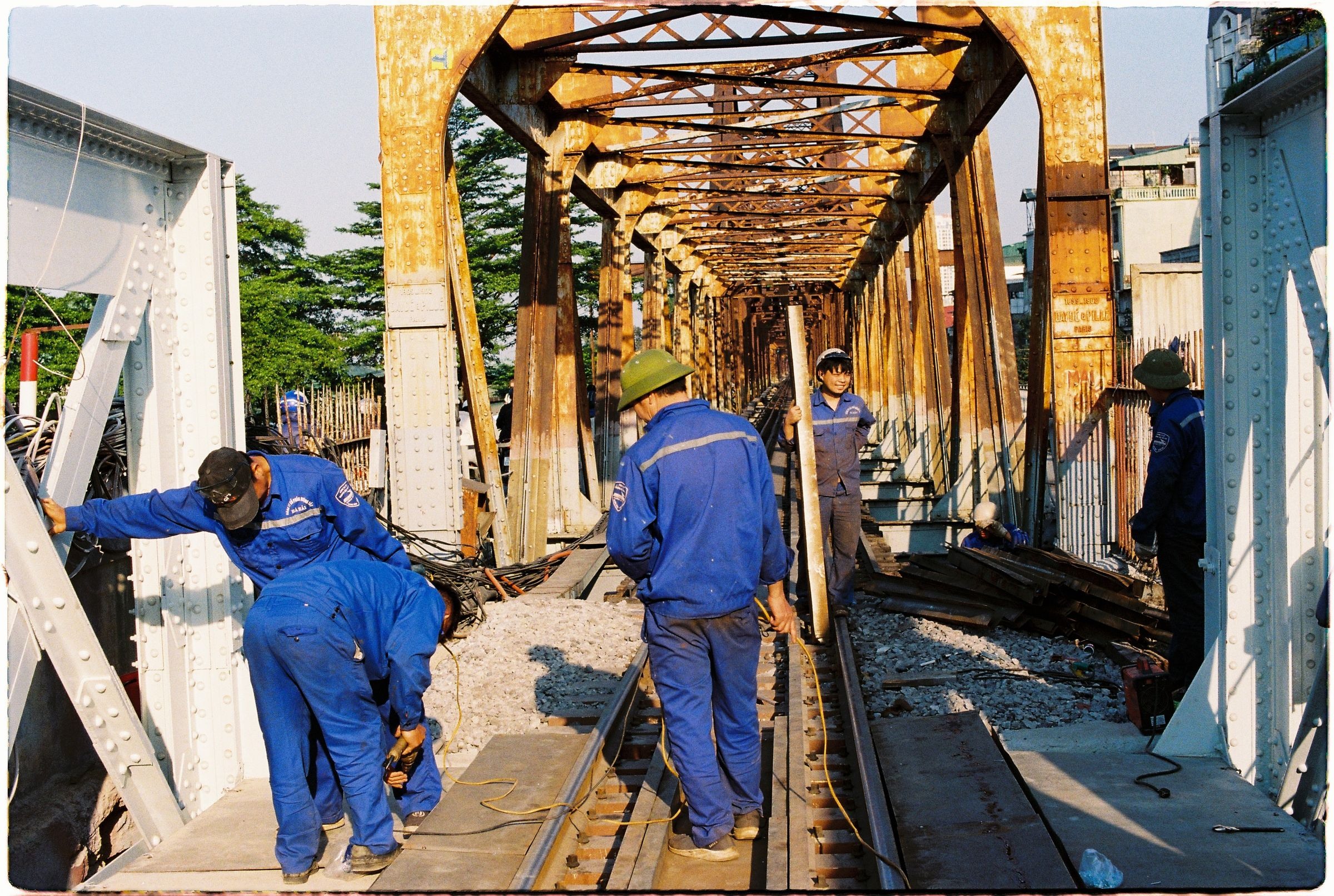Workers maintaining a steel bridge structure