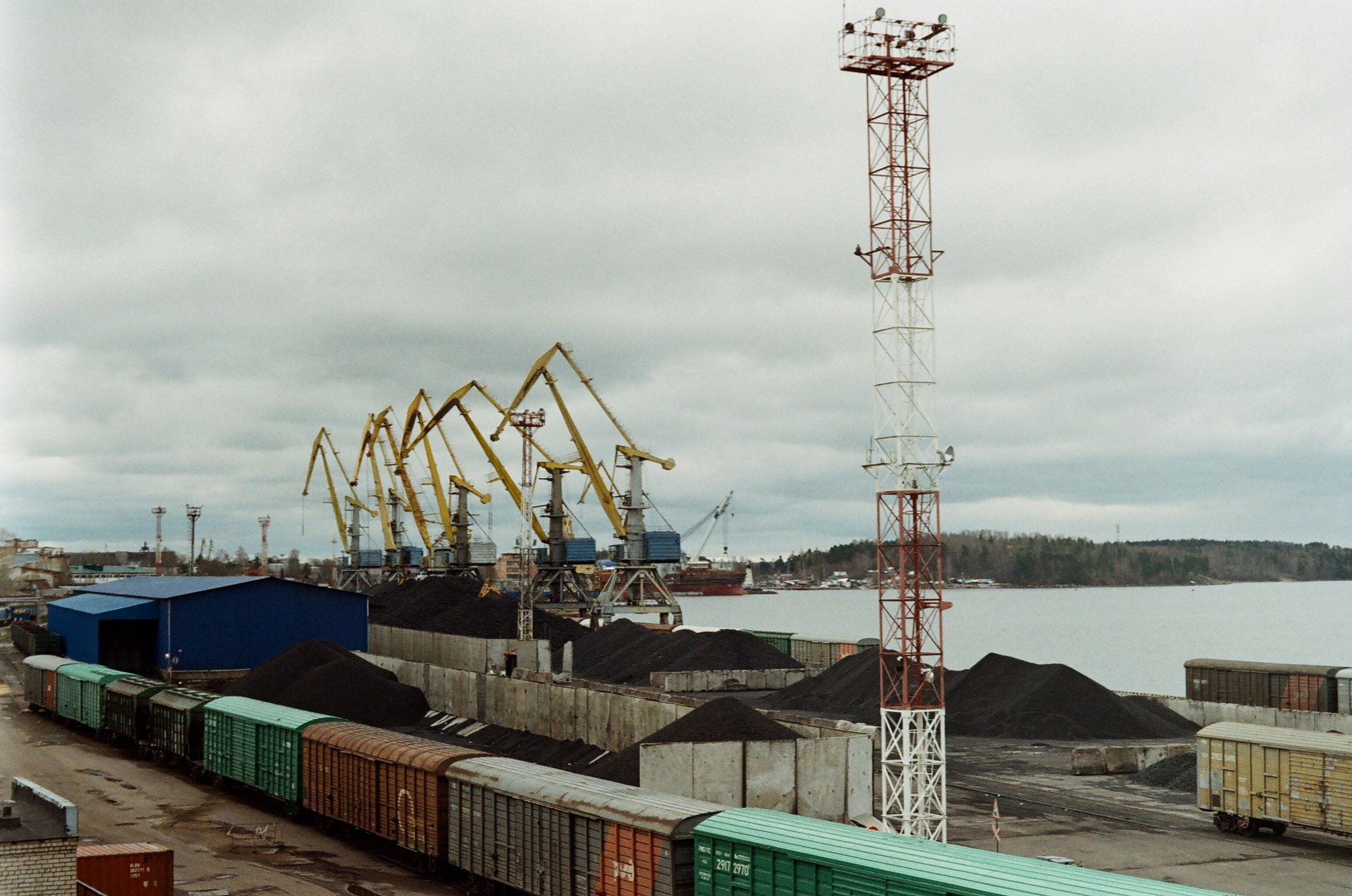 Rail wagons, cranes and bulk cargo at a freight terminal