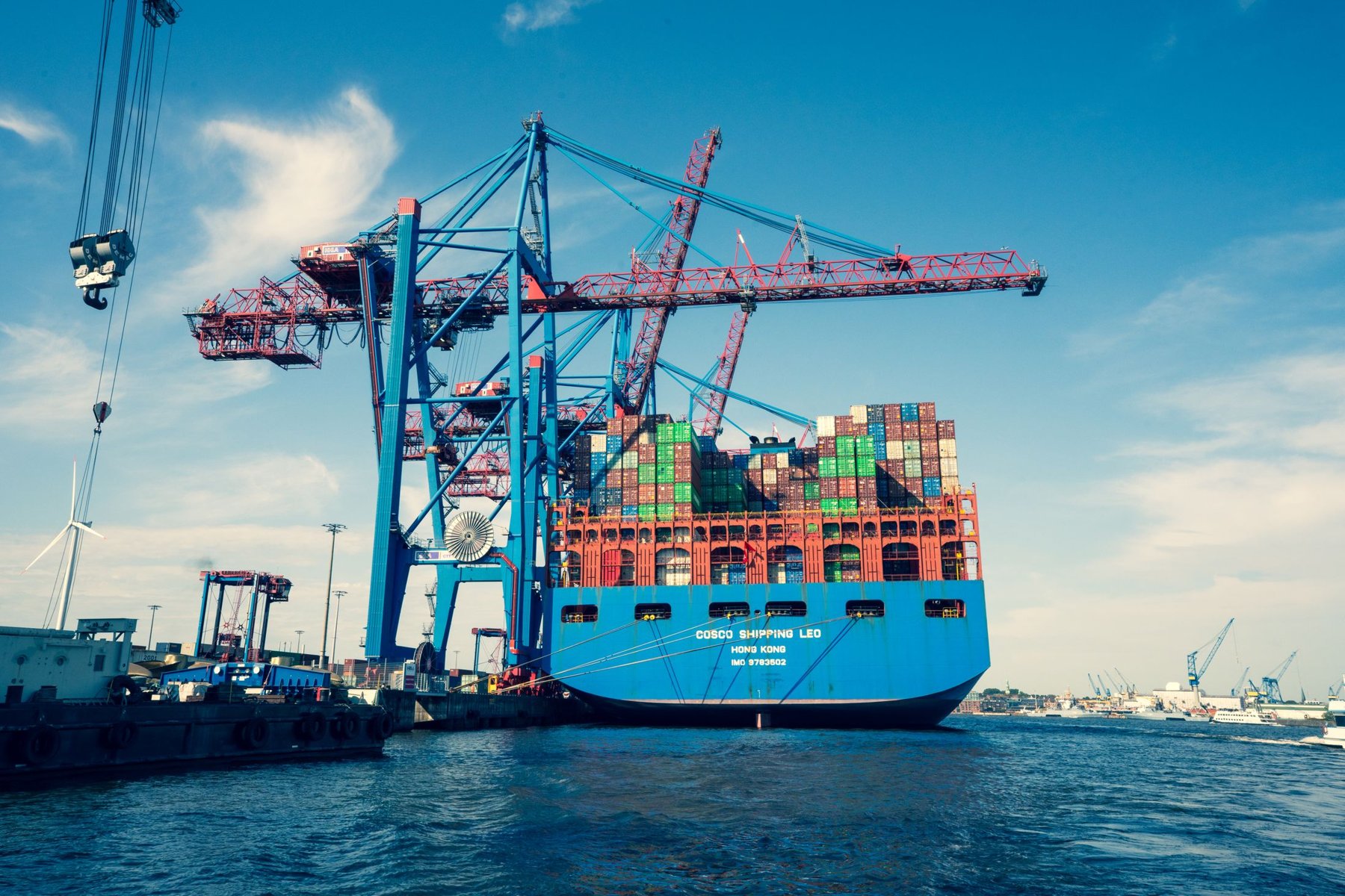 Container vessel beside freight handling cranes
