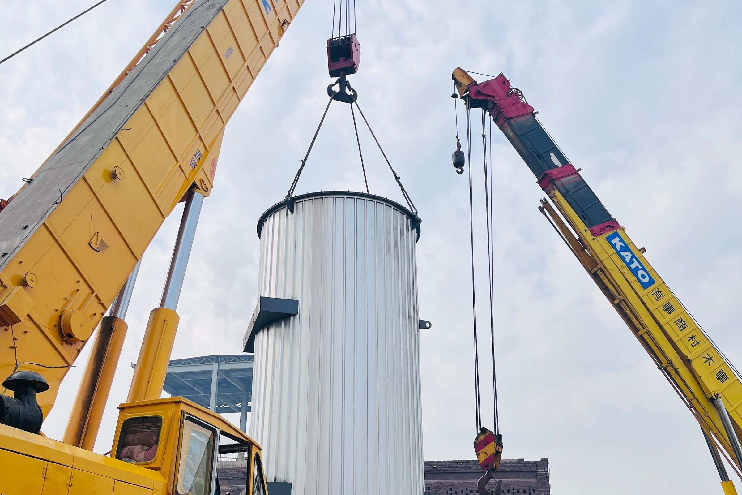 Crane lifting oversize industrial cylinder