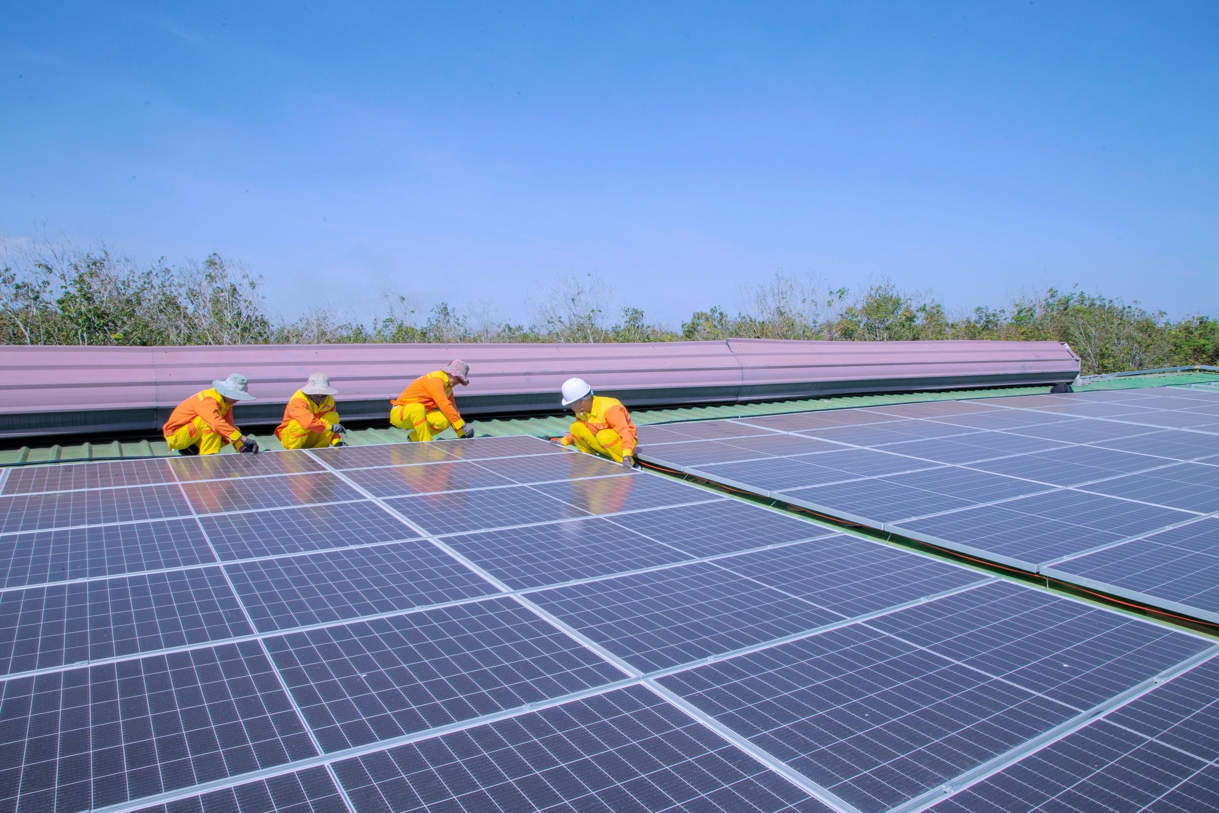 Technicians installing an outdoor solar panel array