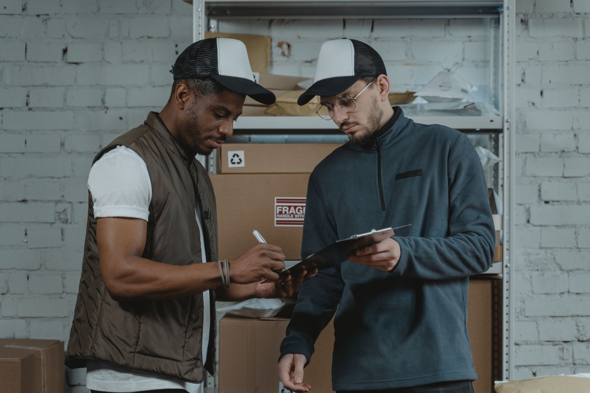 Warehouse colleagues reviewing a shipment on a tablet